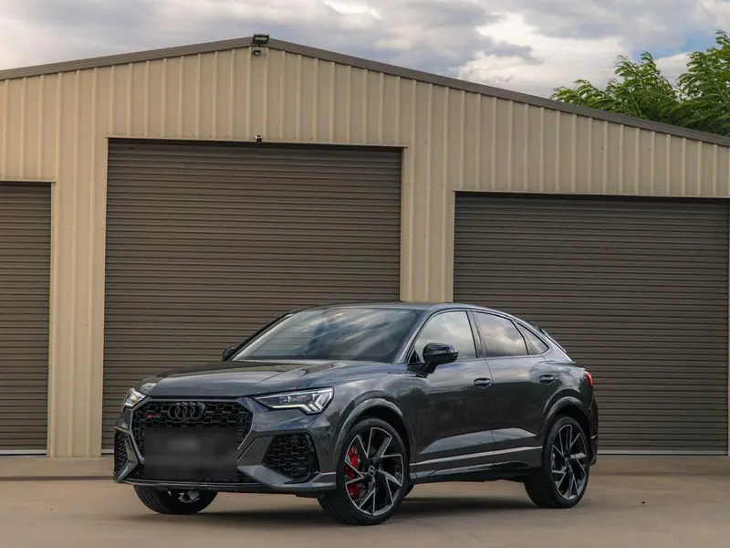 Grey Audi RS Q3 with polished paintwork in front of the garage