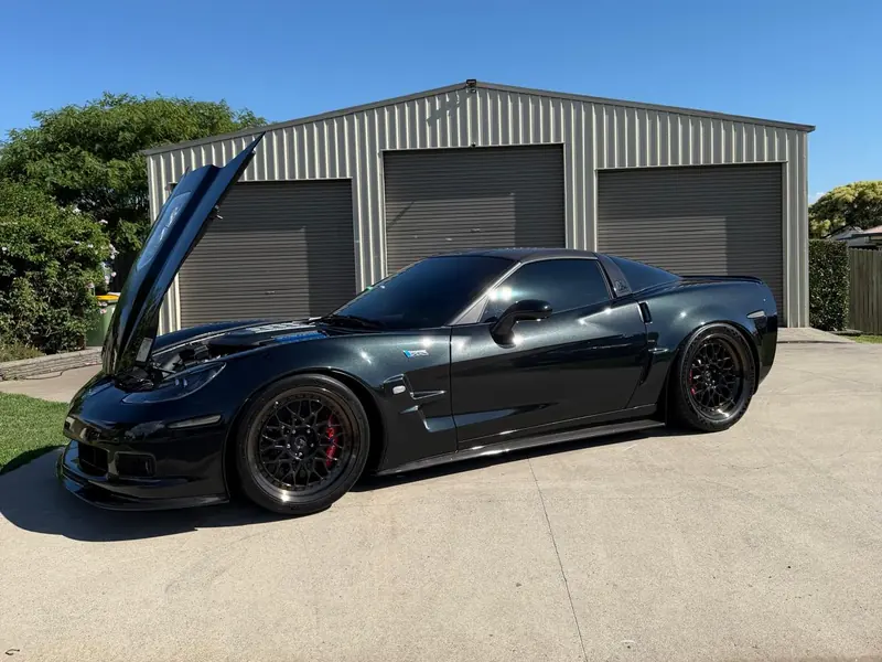 Black Chevrolet Corvette with the carbon bonnet raised after a detail