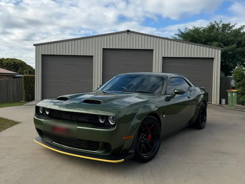 Green Dodge Challenger widebody detailed on the driveway