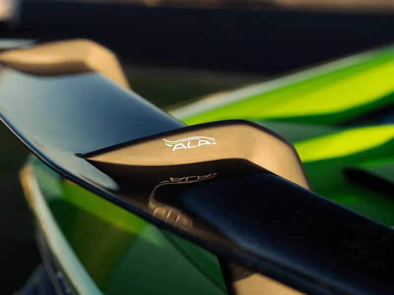 Close-up of the coated active rear wing on a green Lamborghini Huracan