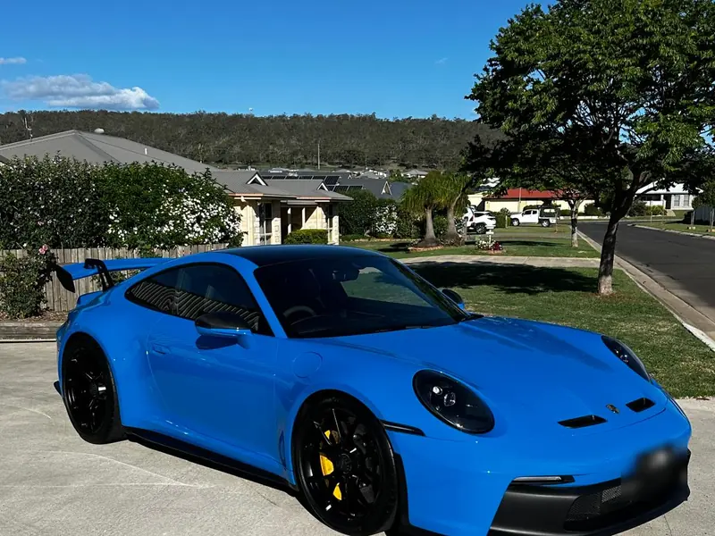 Blue Porsche 911 GT3 after a ceramic coating on the driveway