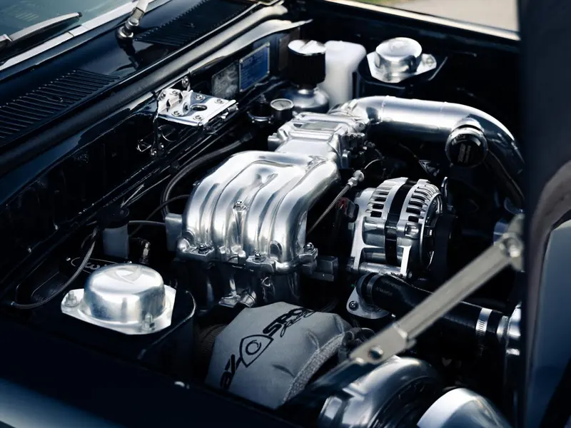Polished supercharged engine bay in a classic muscle car after a detail