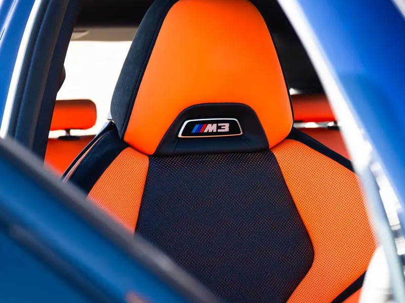 Orange BMW M3 bucket seat after leather cleaning and coating
