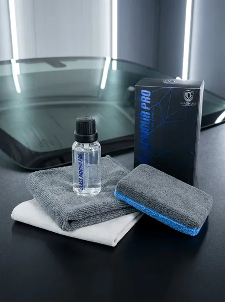 Magnum Glass Armour Pro Ceramic Coating bottle, box and towels beside a windscreen