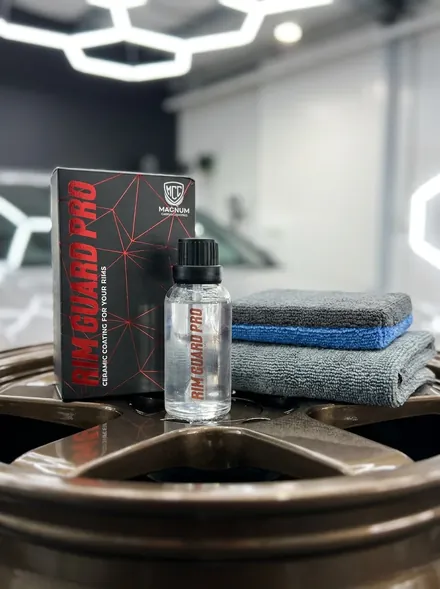 Magnum Rim Guard Pro Ceramic Coating box and bottle standing on a bronze alloy wheel