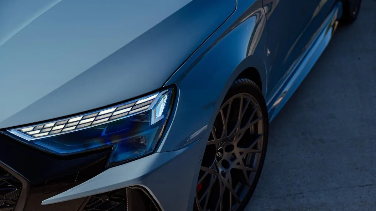 Close-up of a corrected Audi RS3 headlight and front quarter reflecting cleanly