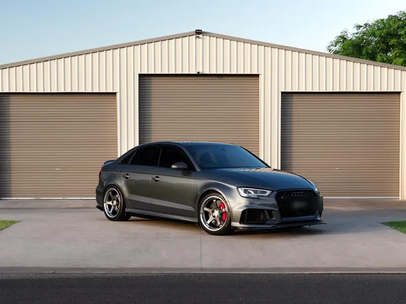 Grey Audi RS3 with corrected high-gloss paint outside the garage