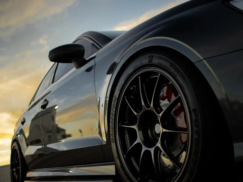 Corrected paintwork and wheel on an Audi flank at sunset