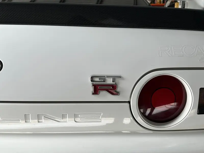 GT-R badge and tail light on a corrected white Nissan Skyline